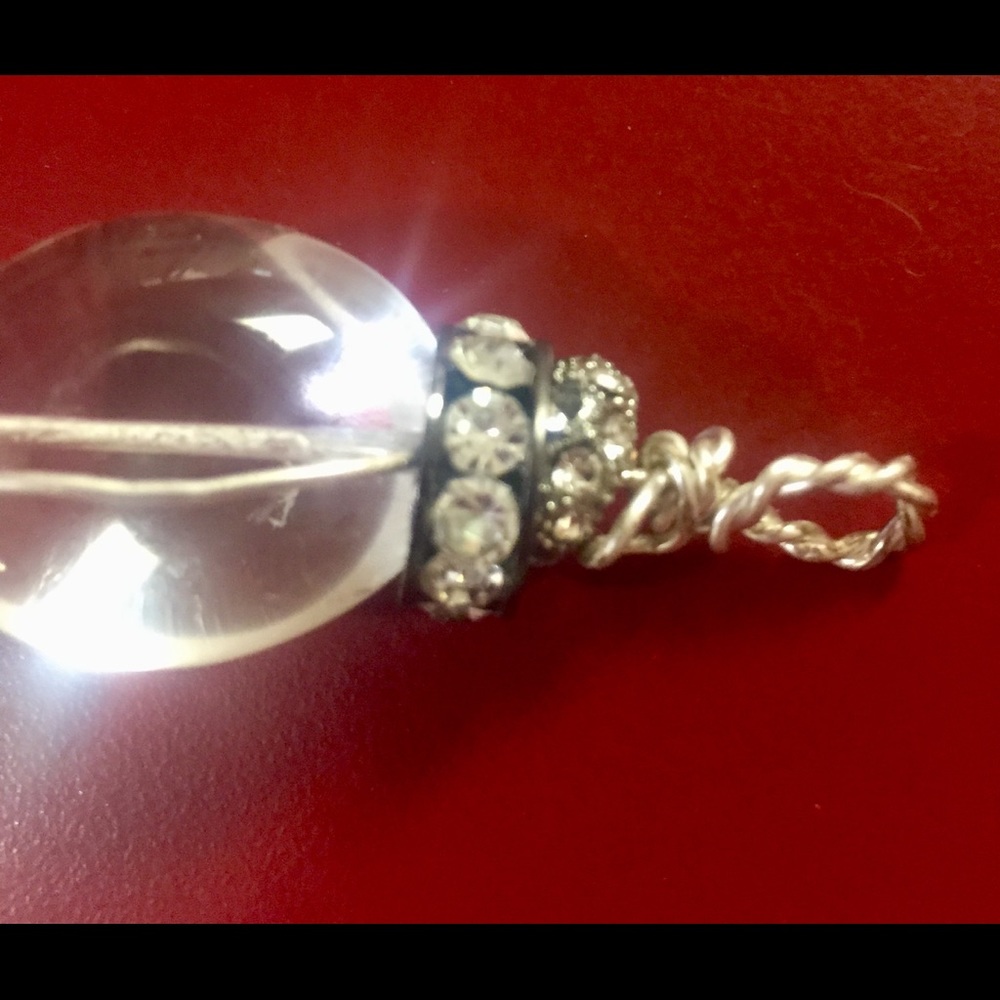 Clear crystal quartz pendant with rhinestones.